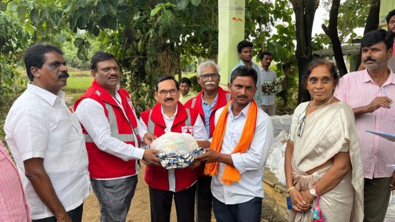 Dr. Nehru Nayak distributes the essential commodities to flood-affected families in Seetharam Thanda.